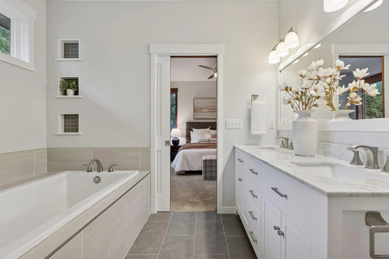 The luxurious ensuite bath features a soaking tub, double vanity, and walk-in tiled shower.