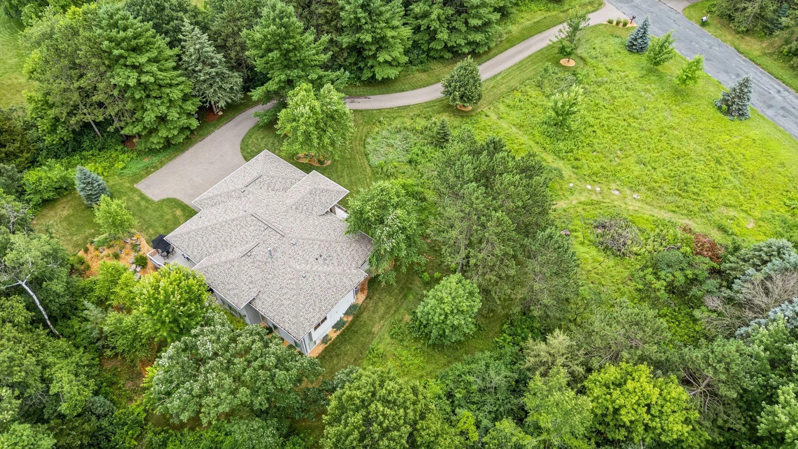 A top-down view of the home highlights the 2-year-old roof and clean modern lines.