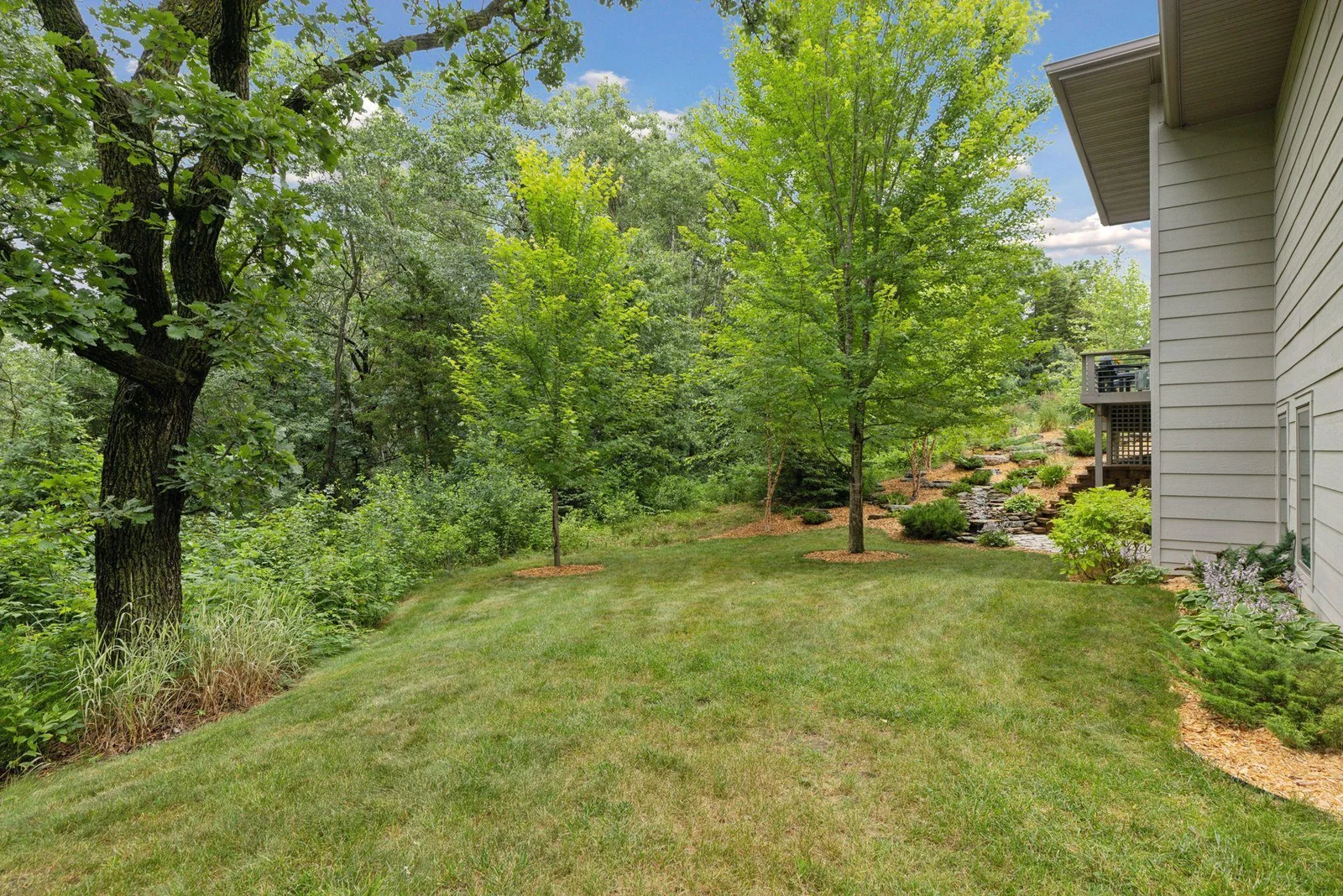 The backyard green space is private, lush, and perfect for relaxation, pets, or play.