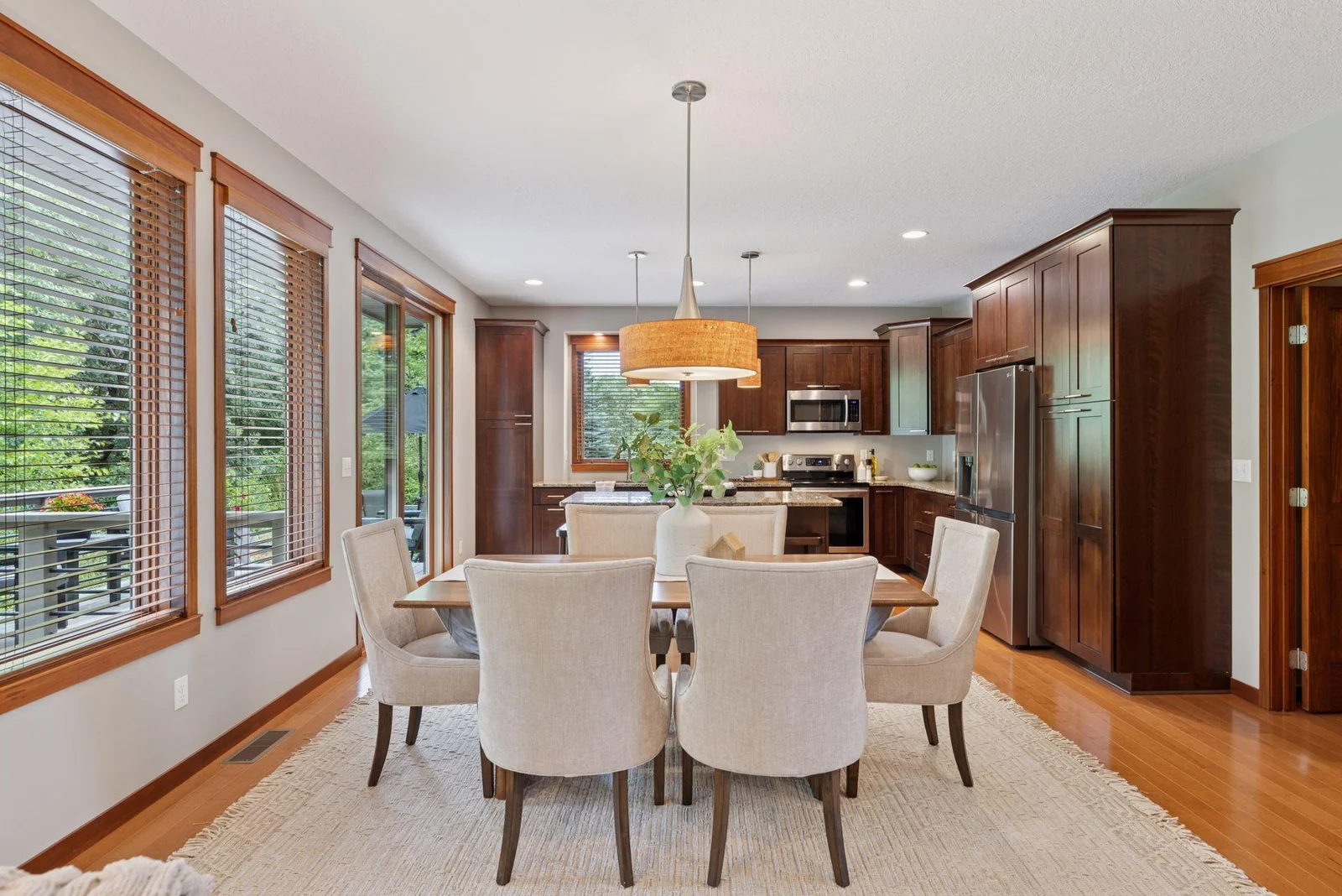 A spacious dining area with statement lighting and room to gather comfortably.