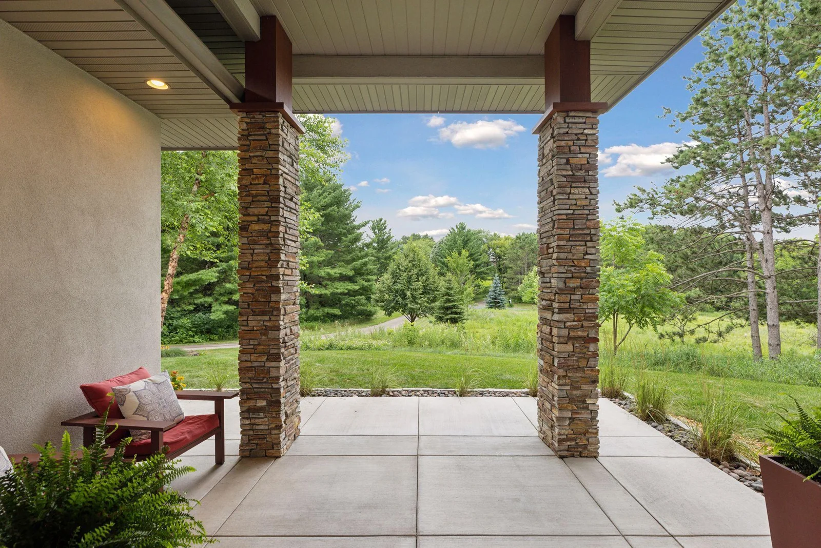 The front porch is the perfect place to relax or welcome guests with a view of your private drive.