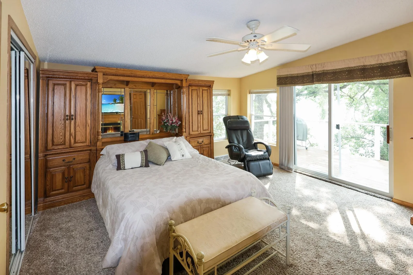Main house- main floor primary bedroom with a balcony, huge walk in closet and private en-suite..jpg
