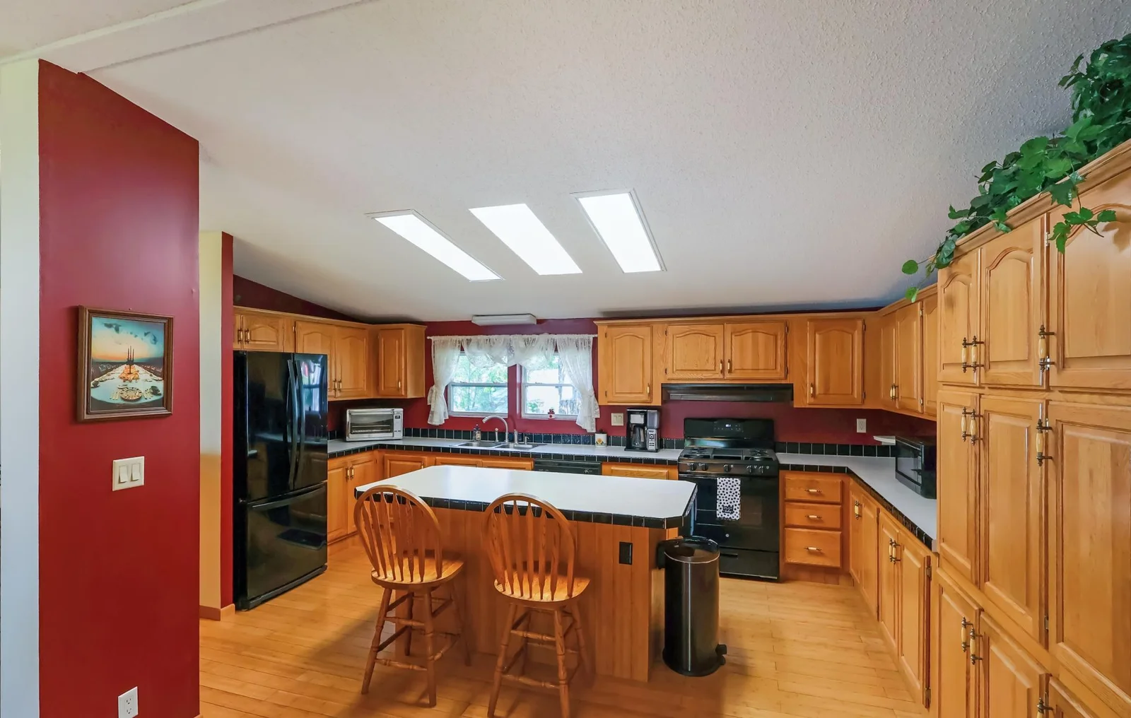 Main house- spacious kitchen with a center island and tons of cabinet space..jpg