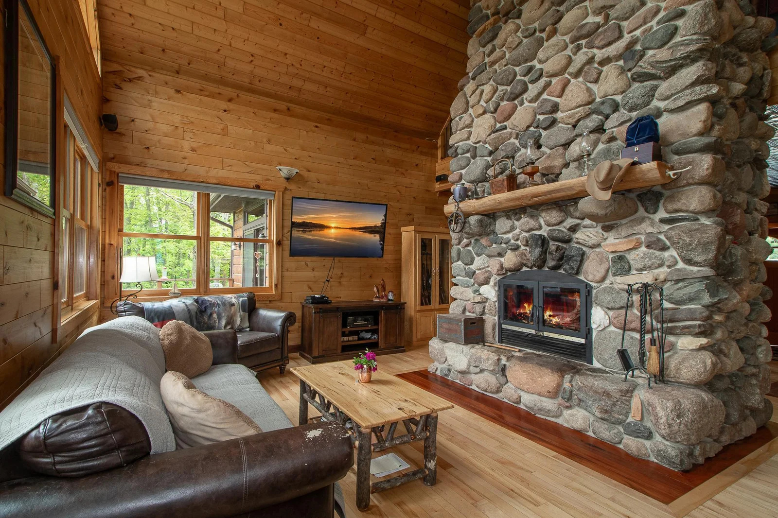 Stone wood burning floor to ceiling fireplace