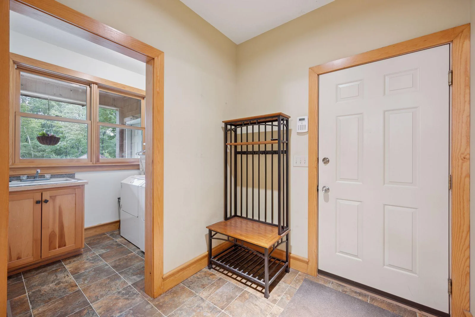 Main level mudroom & laundry room with sink, access to the attached garage.