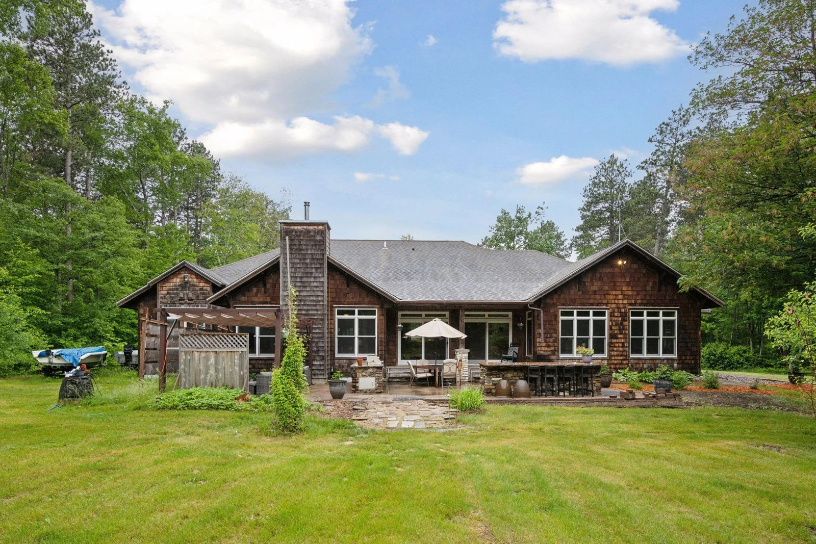 Rear view of the home with outdoor entertaining area