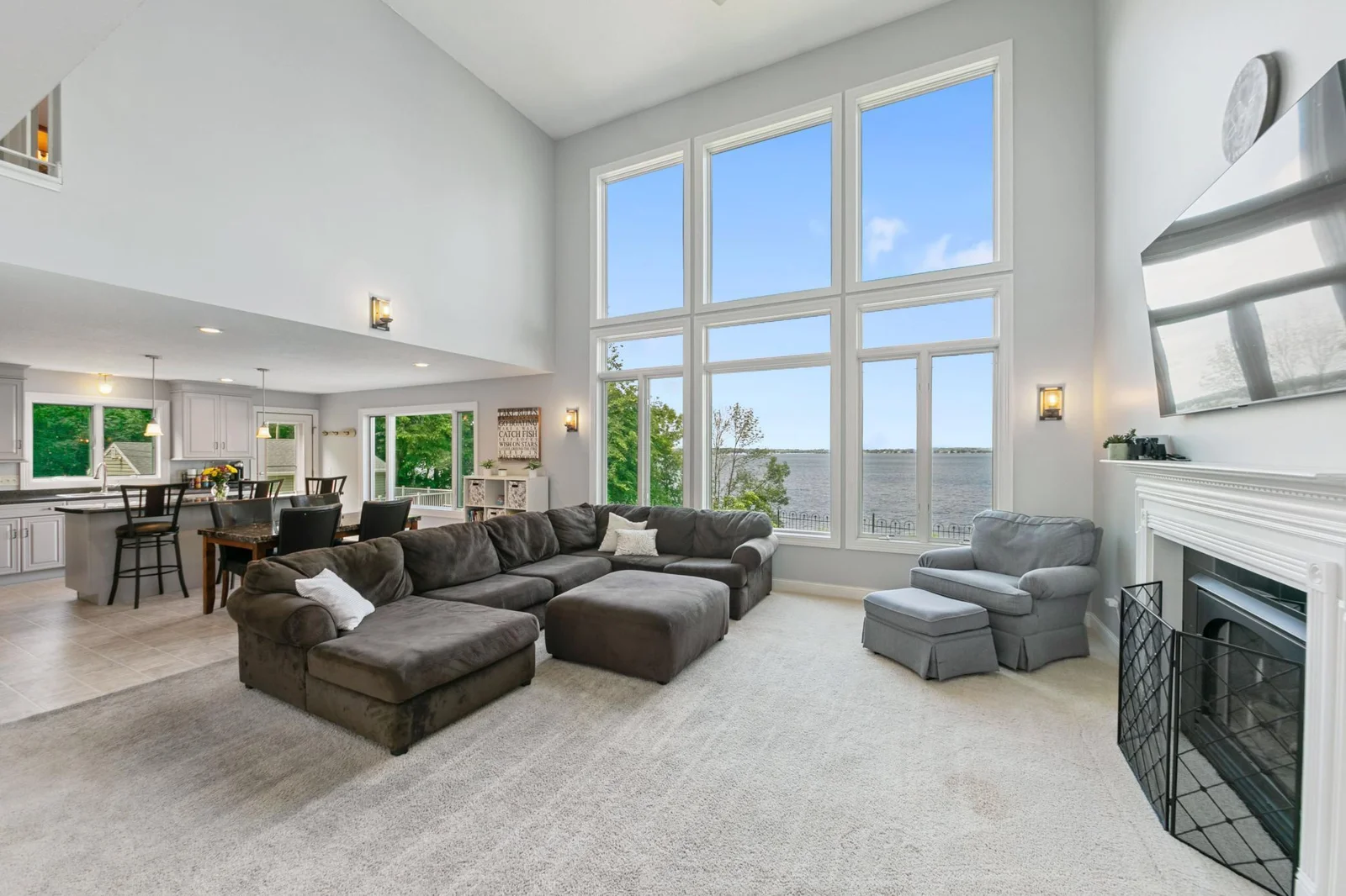 Expansive floor-to-ceiling windows flood the open-concept living space with natural light, seamlessly blending indoor comfort with outdoor tranquility.