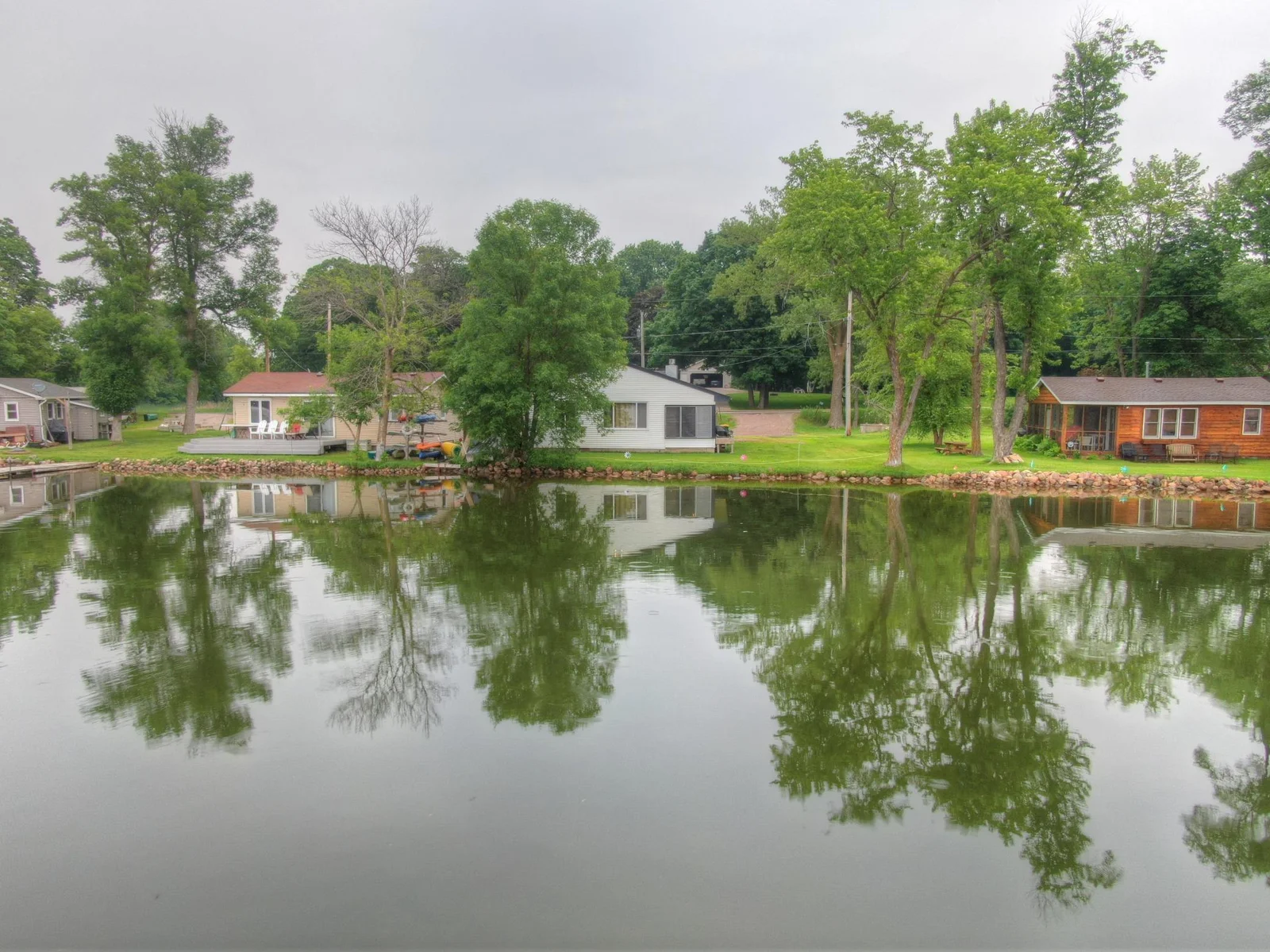 Call today for your private showing of this Lake John property! Hard to find premier lakeshore with no steps down to the water. It is time to make this home your own!