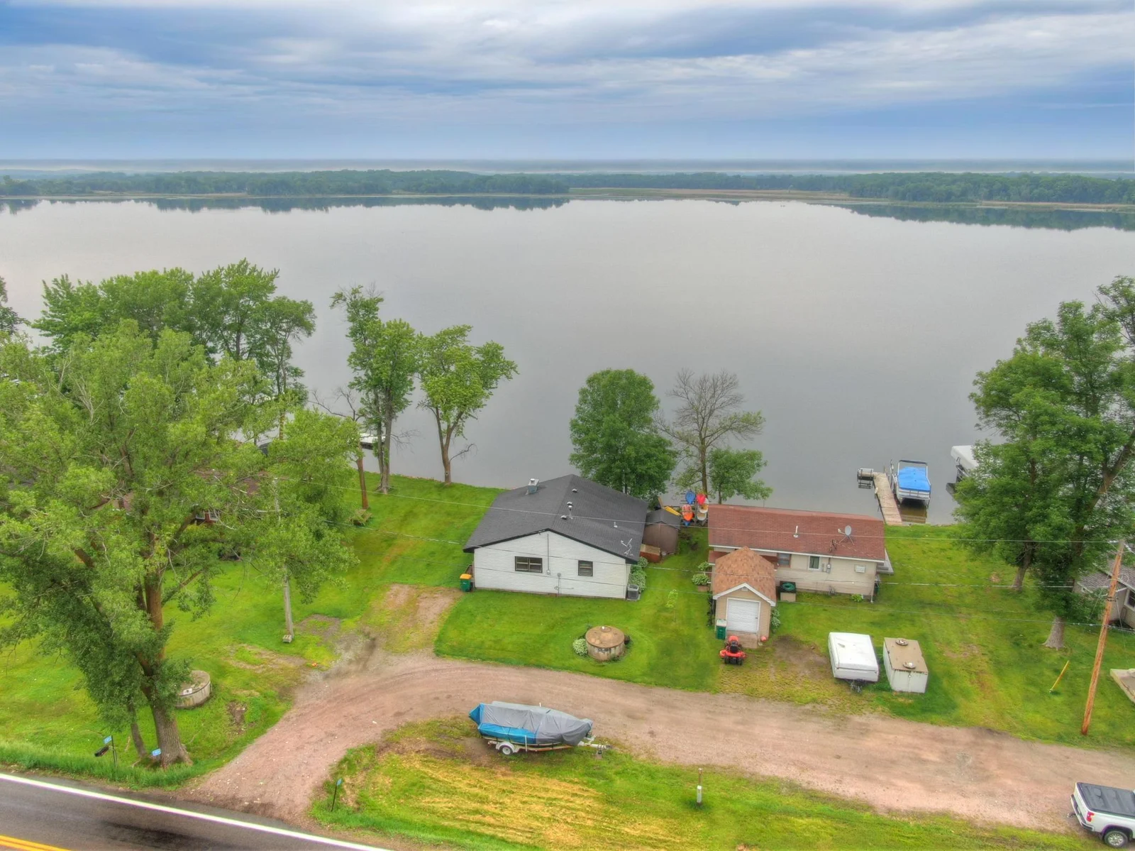 This property offers no steps down to the lake with a natural rock/sand bottom and panoramic Westerly sunset views looking out over Lake John.