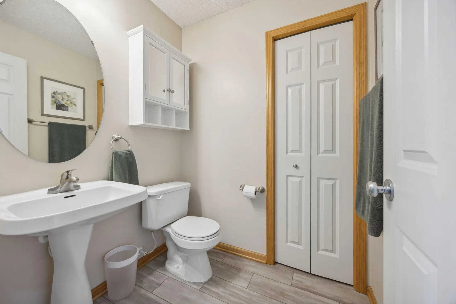 Main floor bathroom. Stylish and ....also functional. Storage closet and the owned water softener easily accessible.