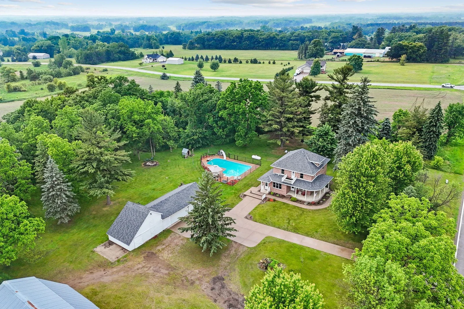 Aerial view with home and four car garage.