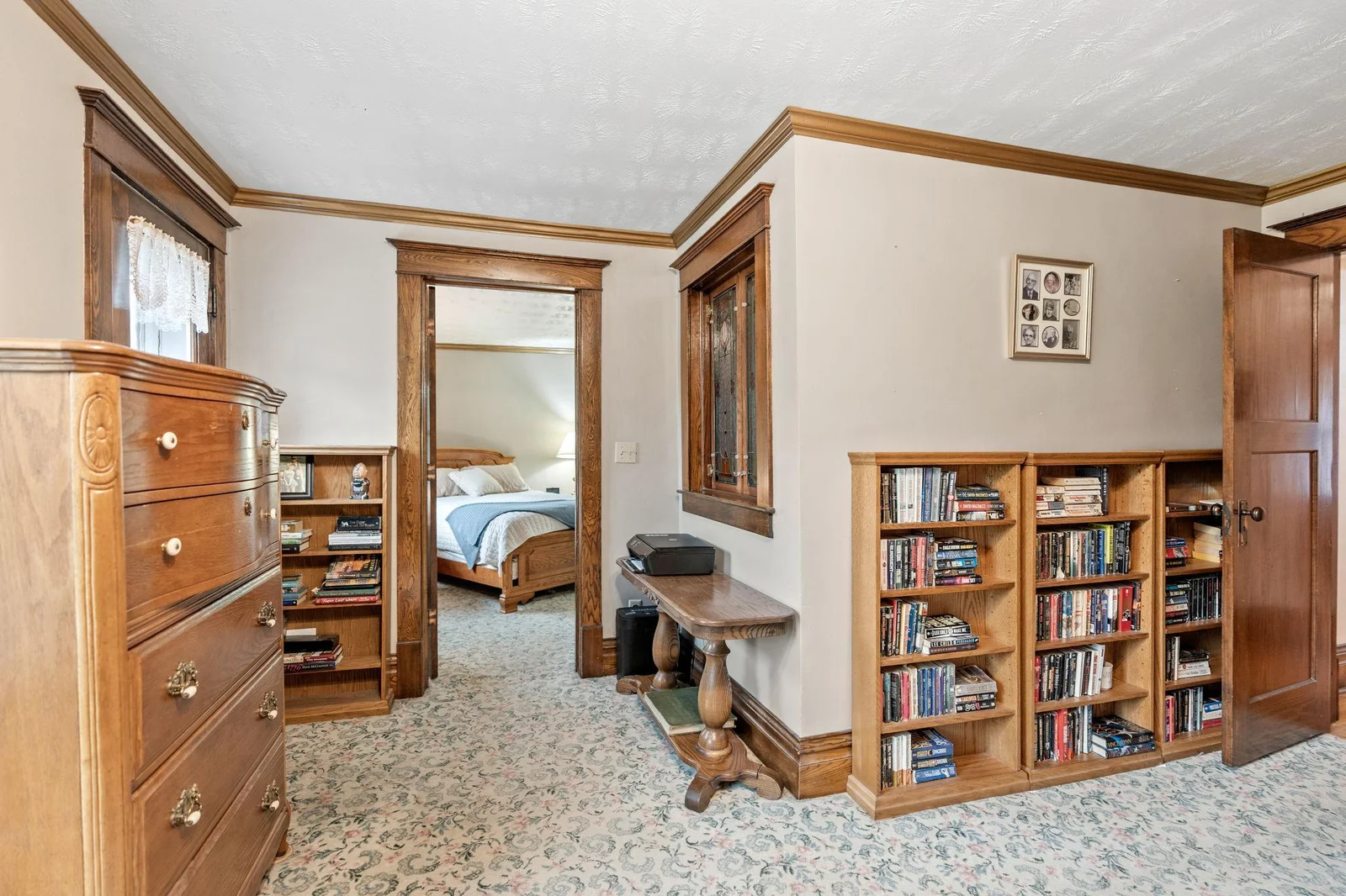 Open space leads into a walk-in closet. Notice the stained glass window feature and a door leading to a balcony.