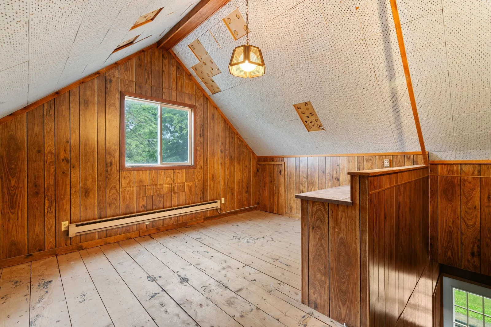 Upper level boinus room has window and door to the eaves