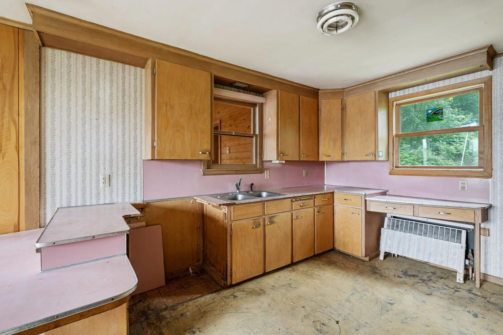 Kitchen has window overlooking the backyard and views out front to the lake