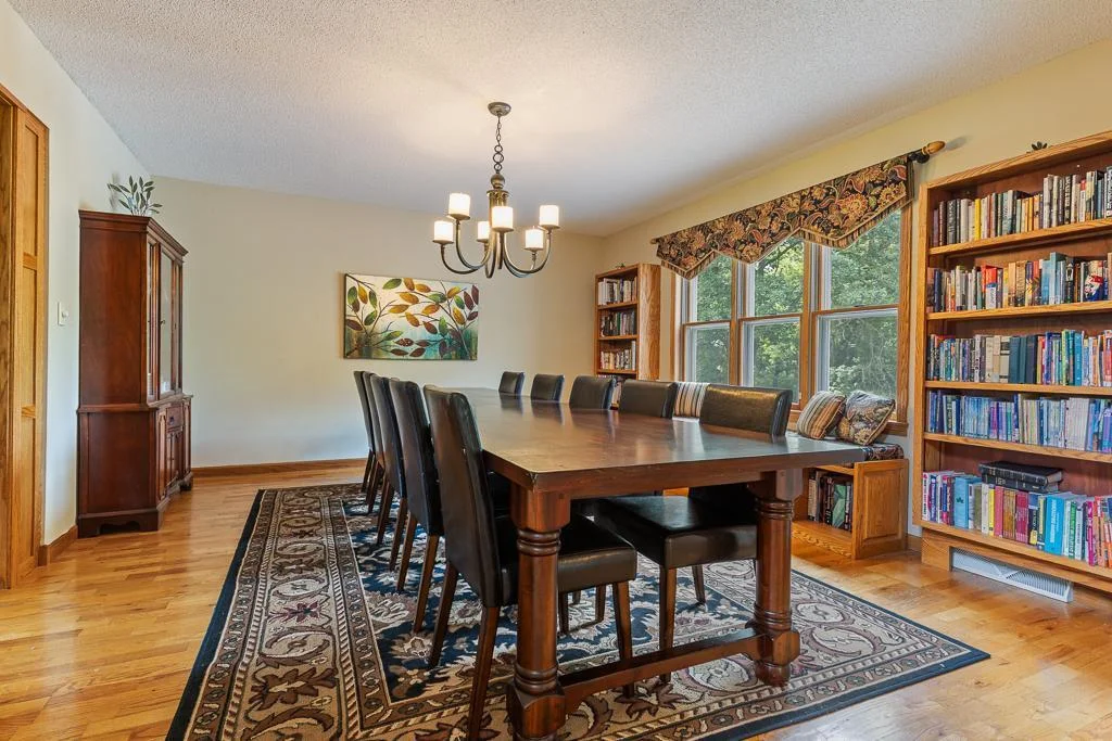 Formal dining features hardwood floors, custom built-ins, and large windows over looking the backyard.