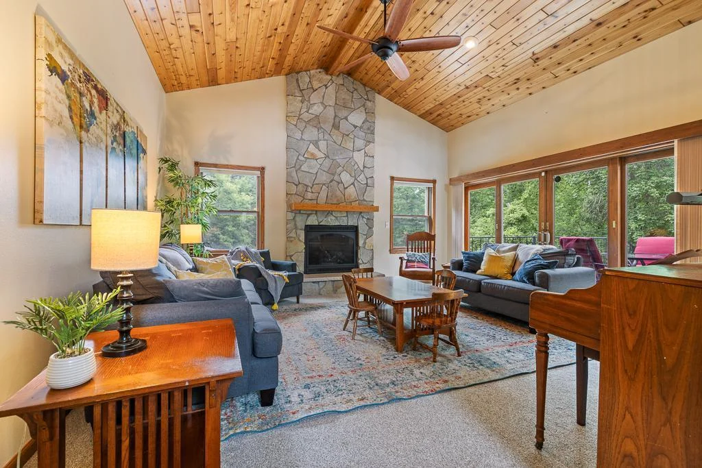 Main level living room! STUNNING rock fireplace feature.