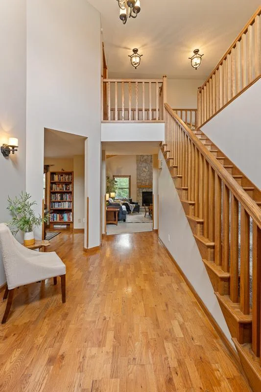 Main floor opens up to a front den, formal dining room, living room, and large kitchen space.