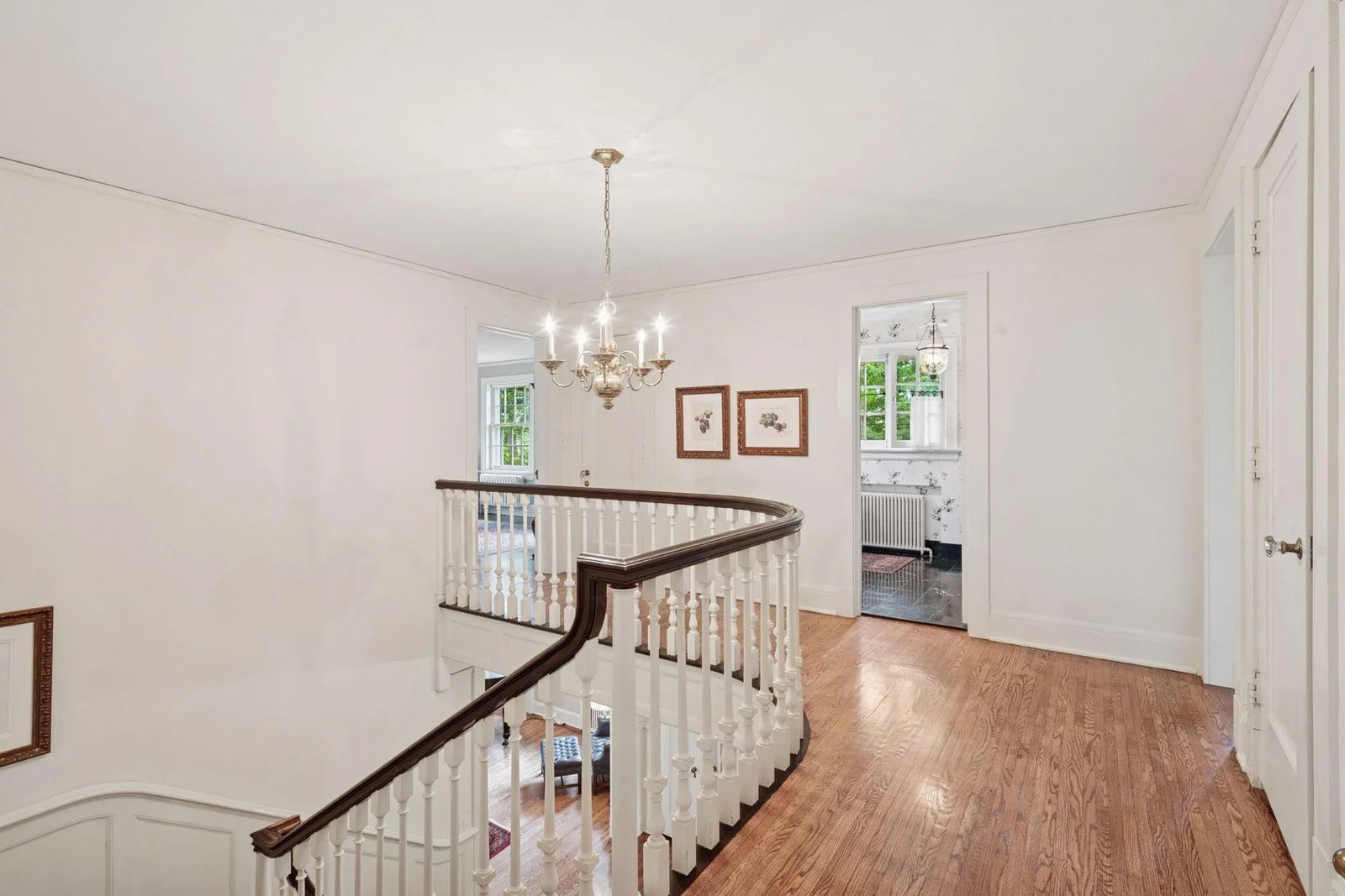 Spacious upper-level landing with hardwood flooring.