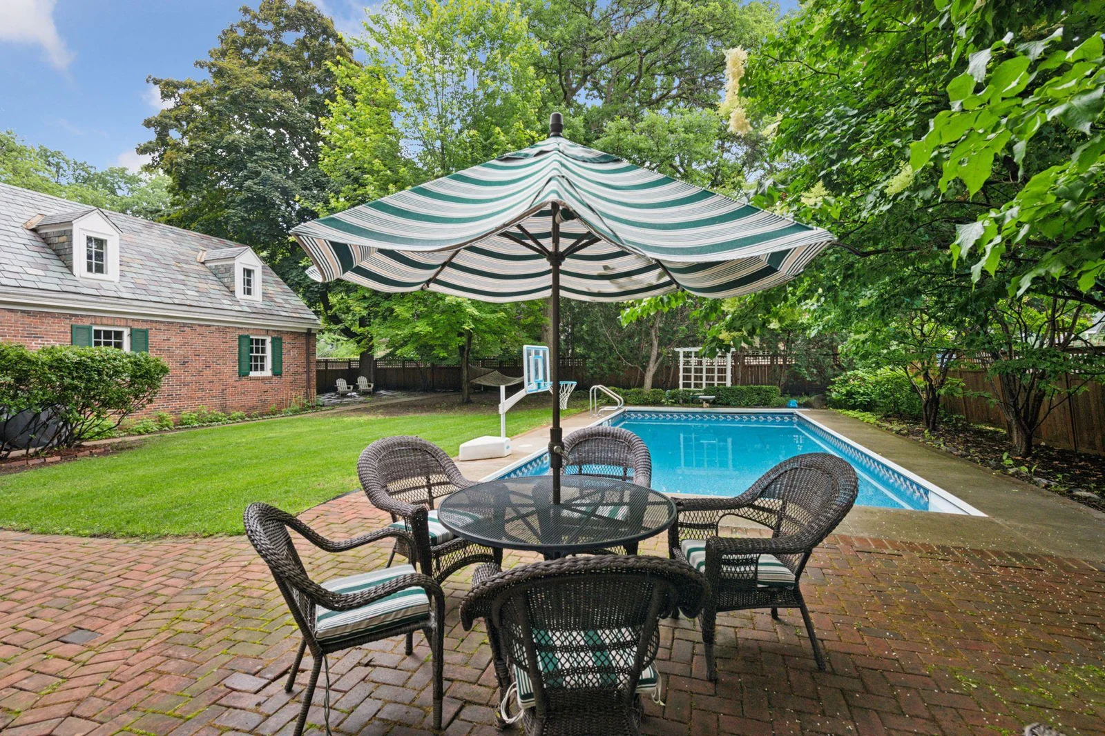 Seasonal dining poolside on the brick patio.