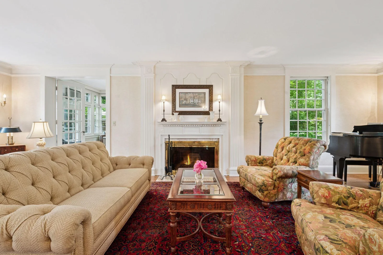 The millwork continues into the Living Room and frames the wood-burning fireplace beautifully.