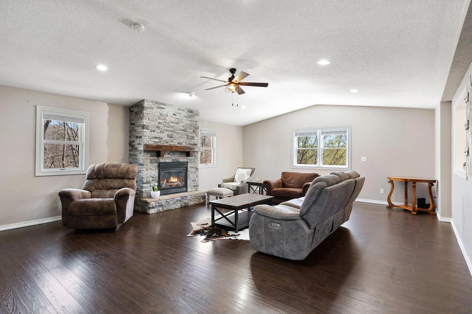 Gorgeous stacked stone fireplace provides warmth and atmosphere.