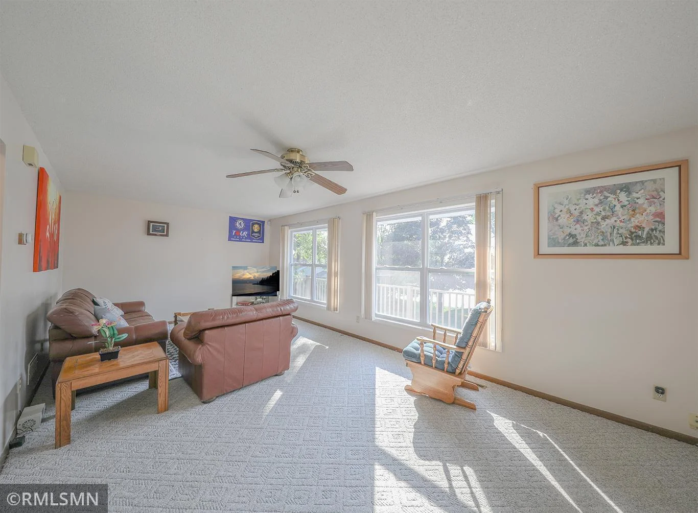 The living room is flooded with light through the brand new windows (2025)