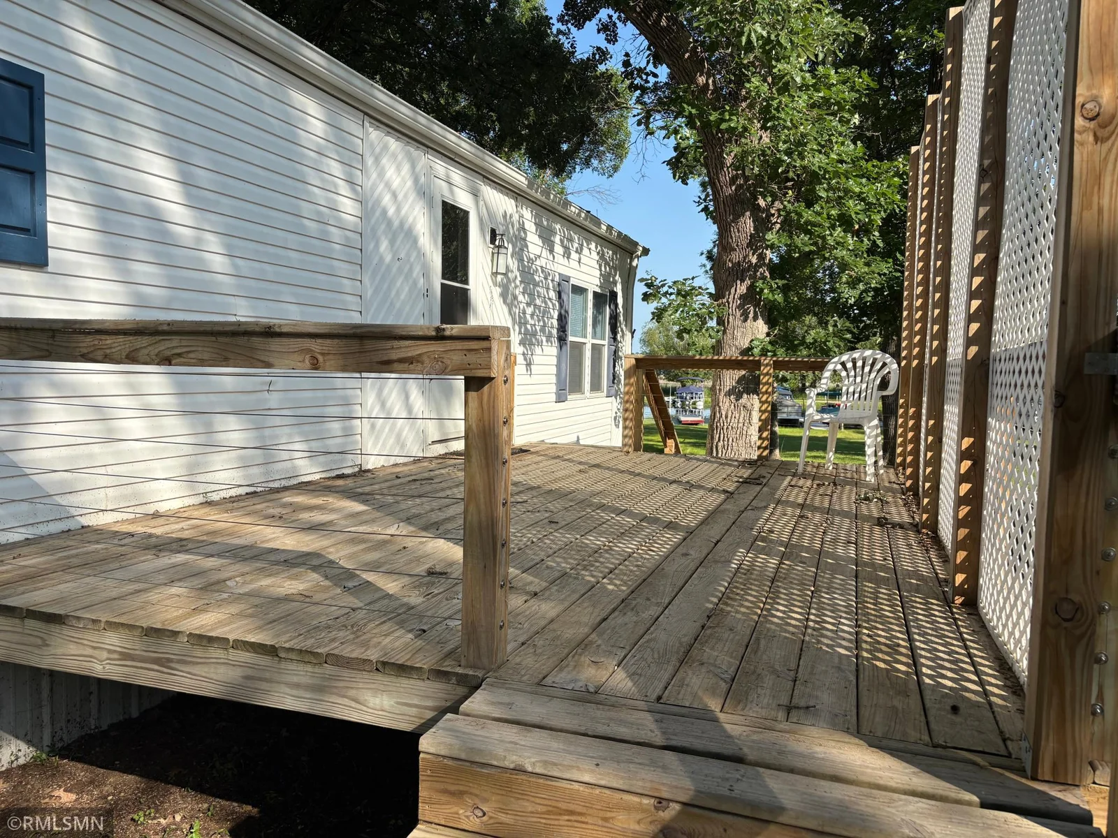 Enjoy outdoor living on the generous side deck, perfect for relaxing or entertaining guests, with lake views as your backdrop.