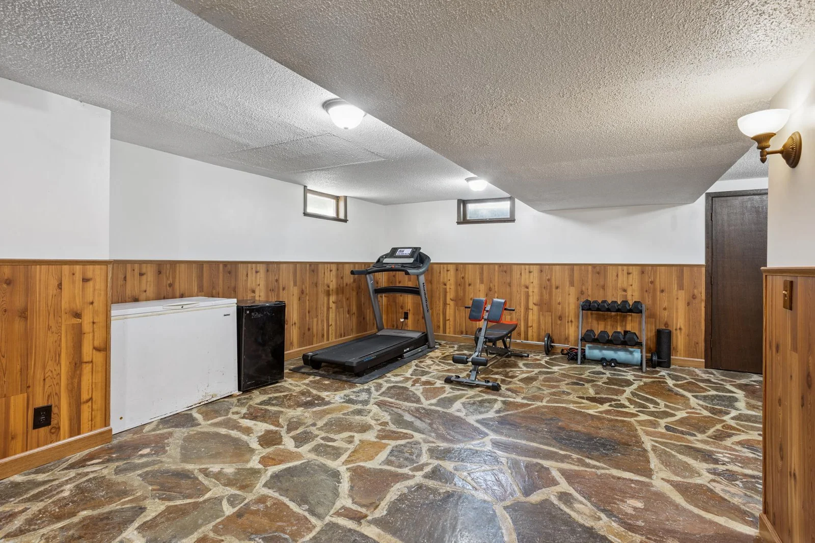 Basement workout space can be used for a playroom or family room