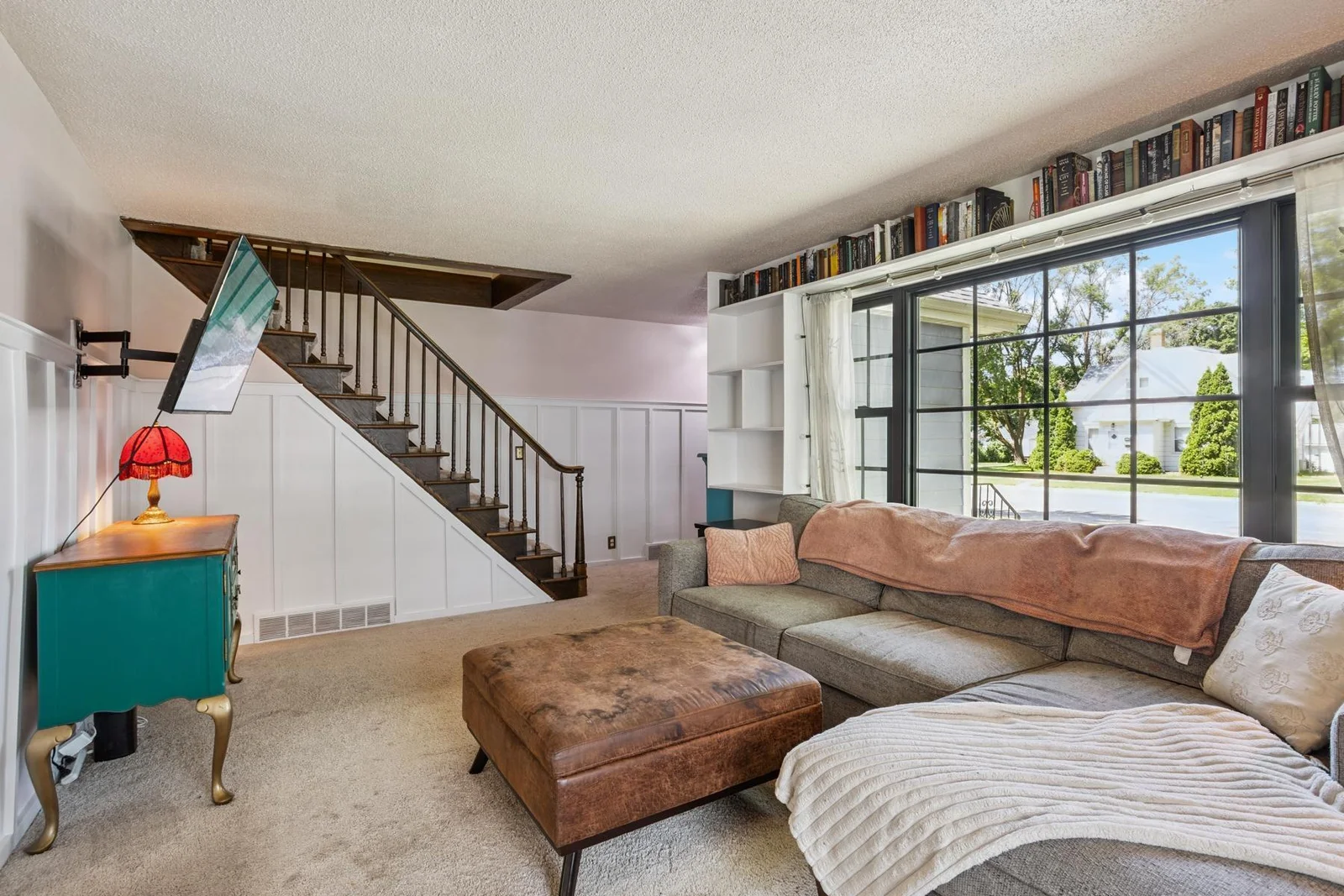 Living room facing foyer and stairs going upstairs