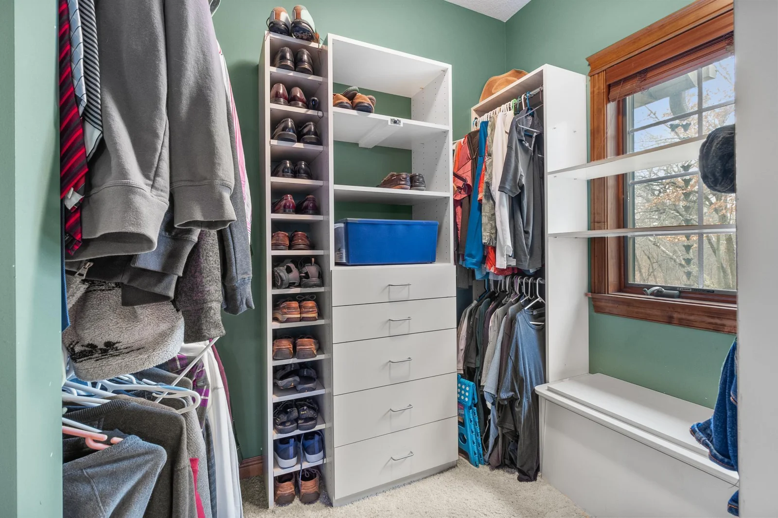 Primary bedroom suite second walk in closet off primary bath. Built-in storage and hanging space.