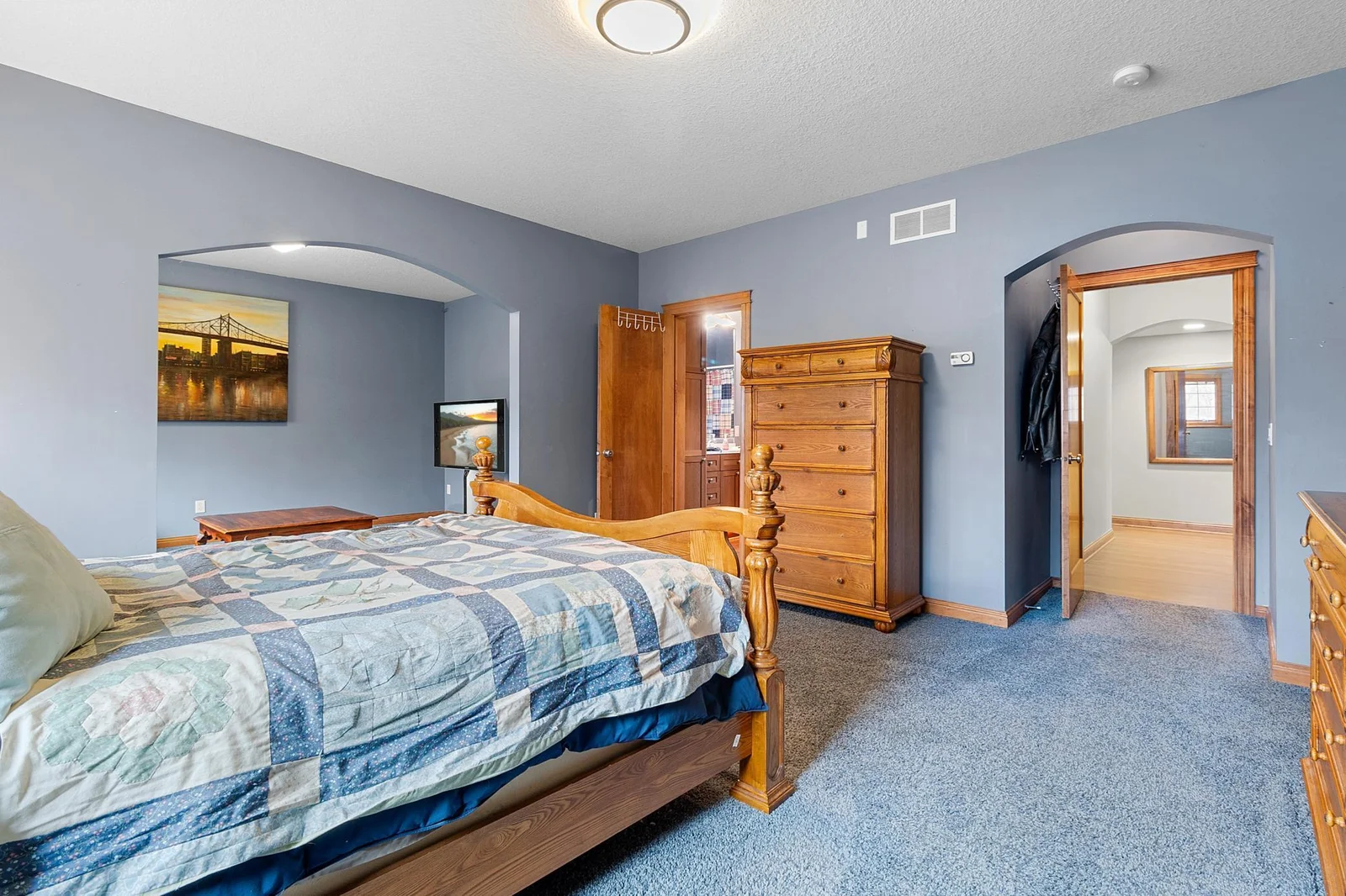 Lower-level first bedroom suite open to separate sitting area and full en-suite bathroom and walk-in closet.