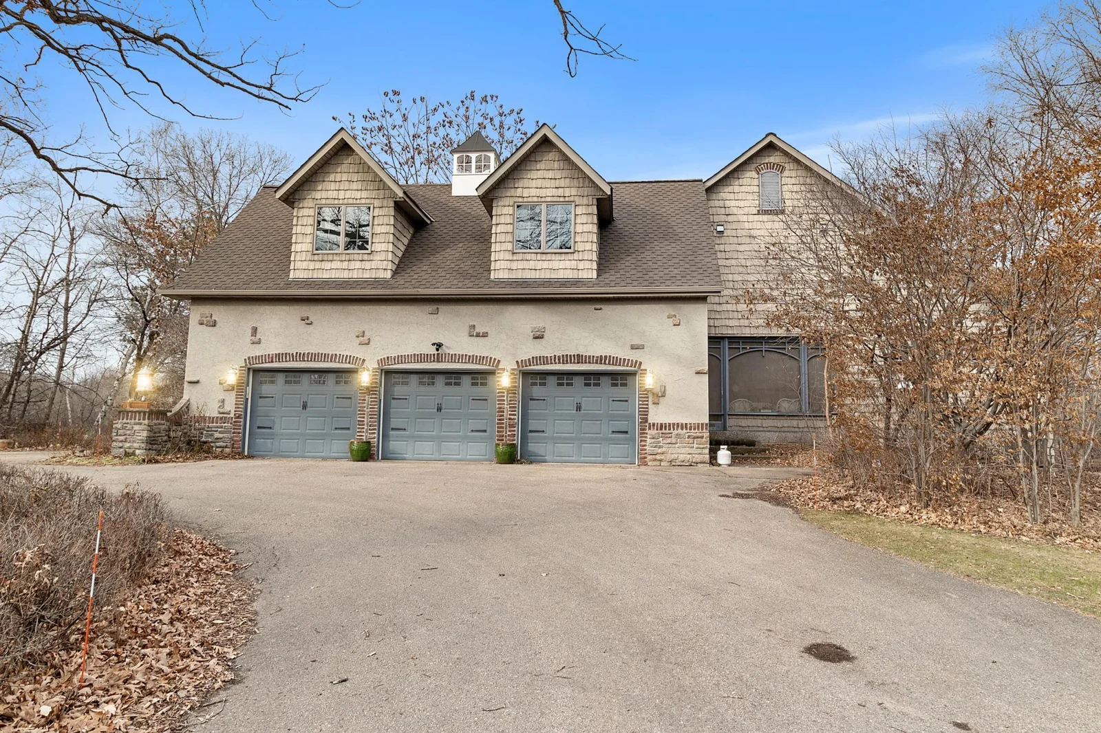 Three stalls in the attached garage are heated and directly access the main hallway of the house. Screened-in porch is shown on the right.