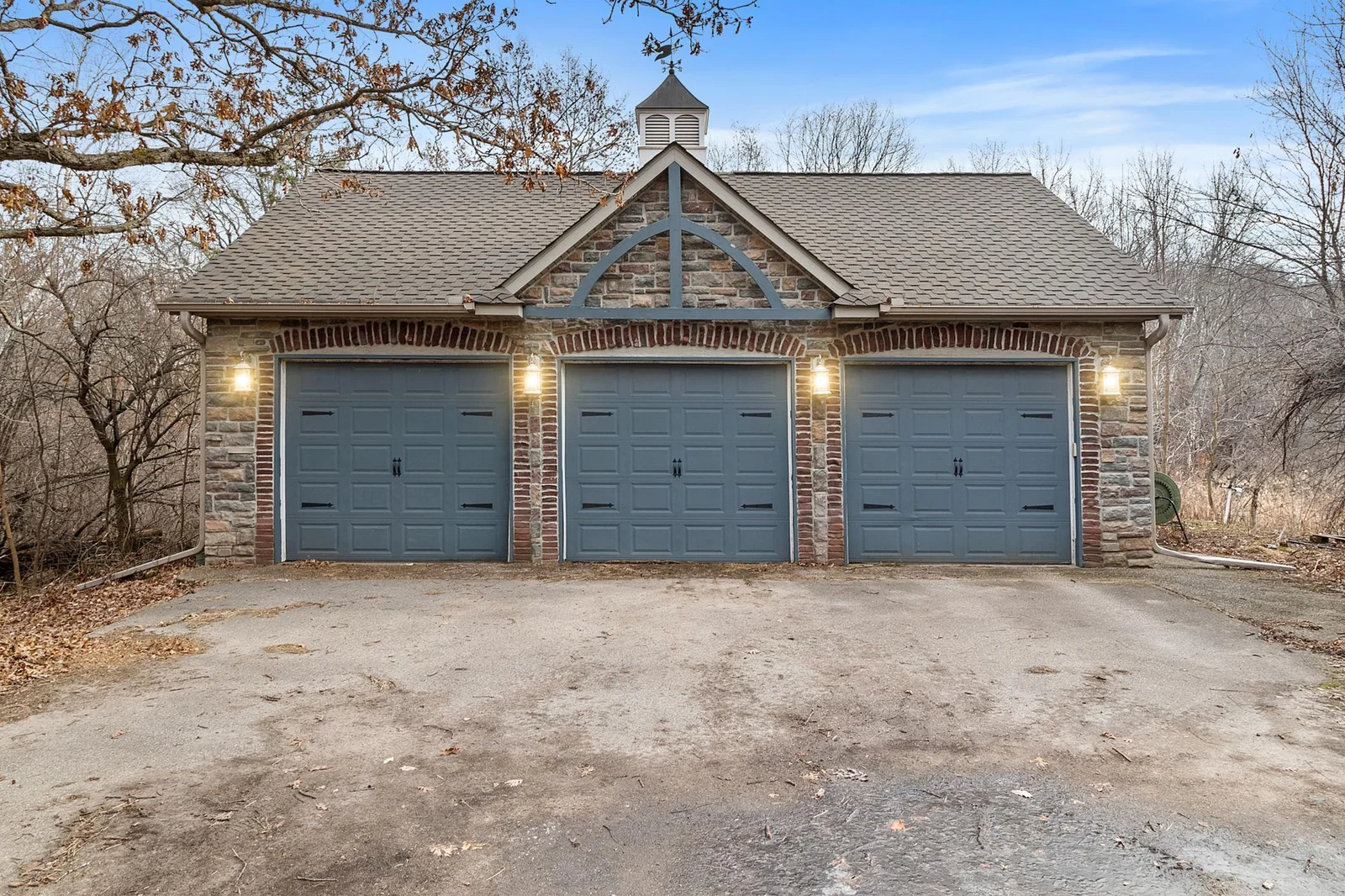 Three stalls of the detached garage have extra-high doors for storage of taller vehicles and recreational equipment.
