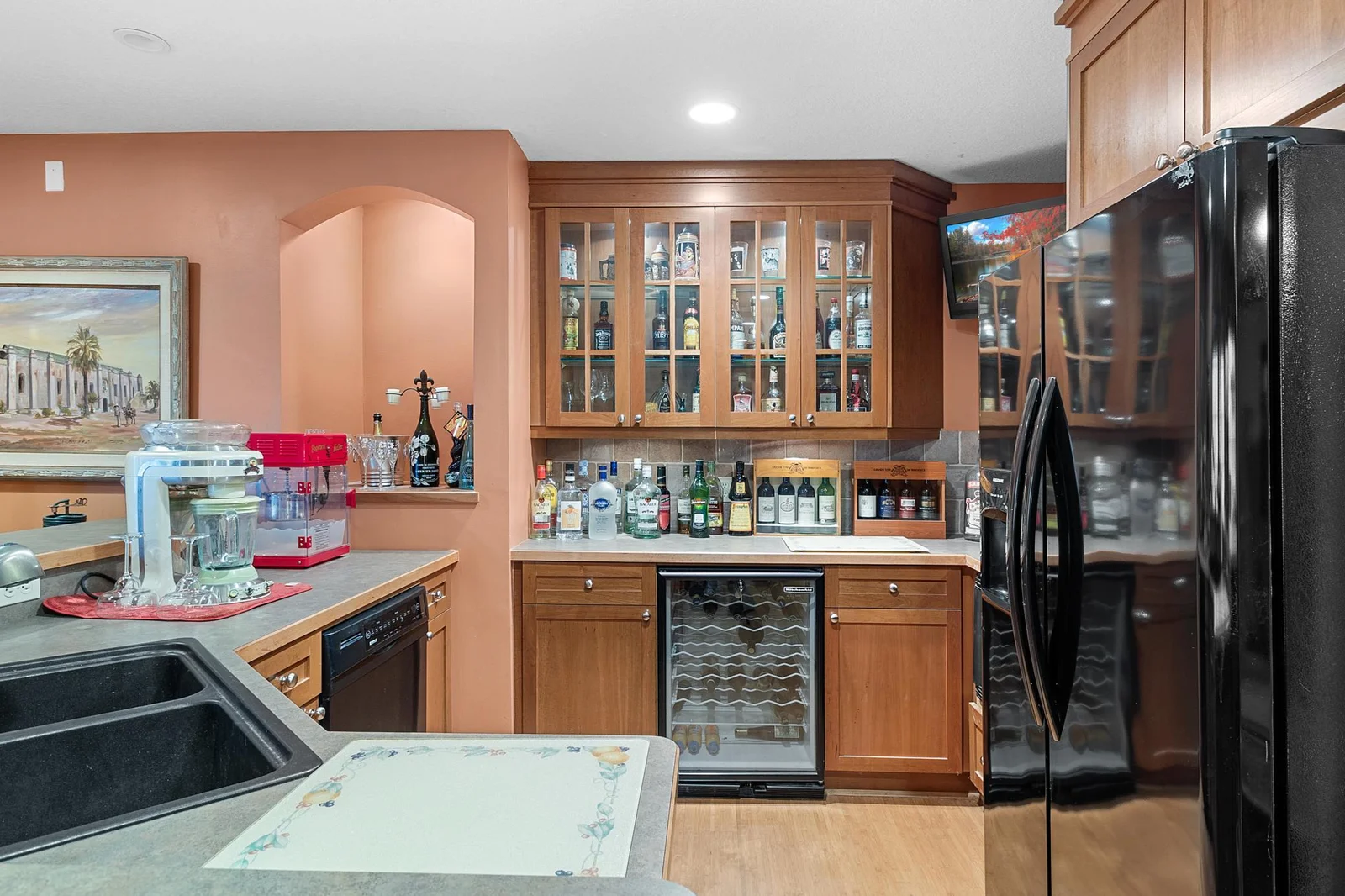 Lower-level recreation room wet bar.  Sink, Garbage disposal, dishwasher, wine refrigerator, refrigerator/freezer with icemaker, microwave