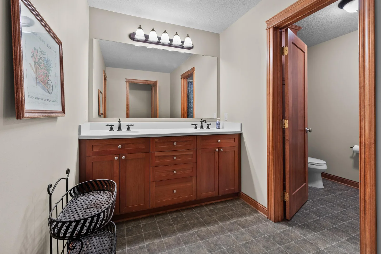 Upper-level full bathroom with dual sinks separate from WC and tub/shower area.