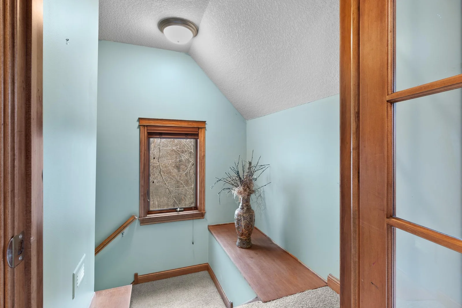 Upper-level stairway access from bonus room / private office to main-level hallway.