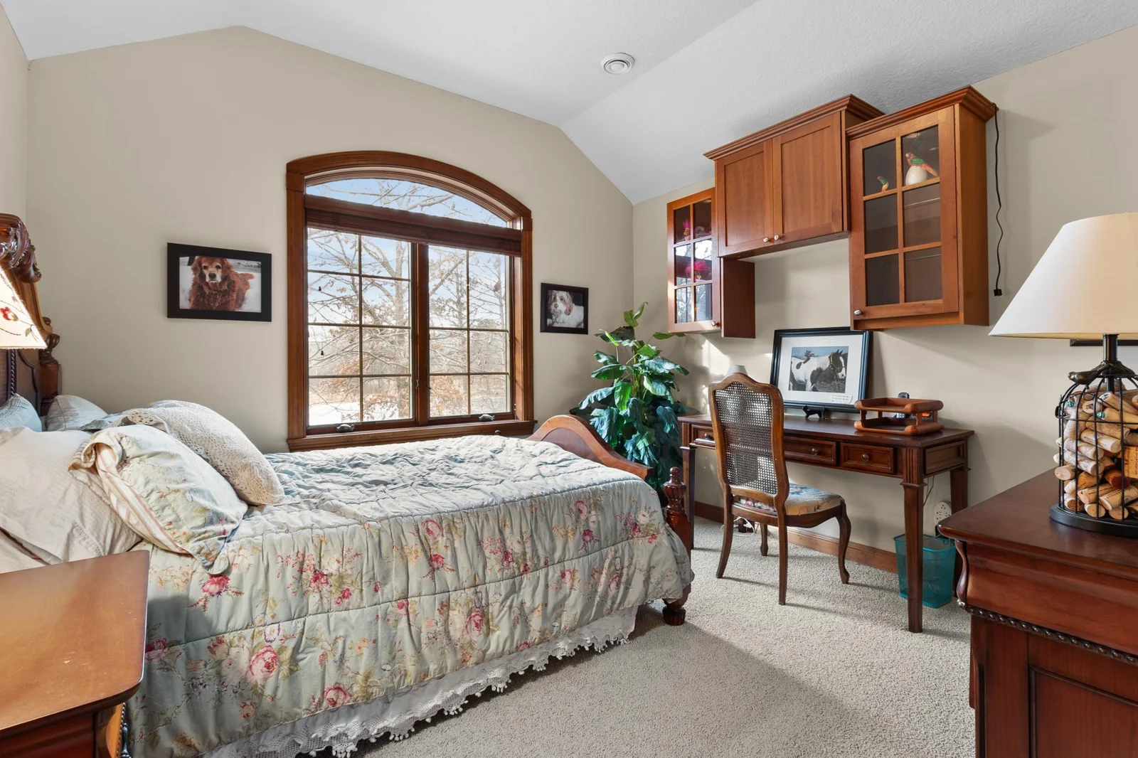 Upper-level second bedroom with view toward front and large natural pond. Walk-in closet.