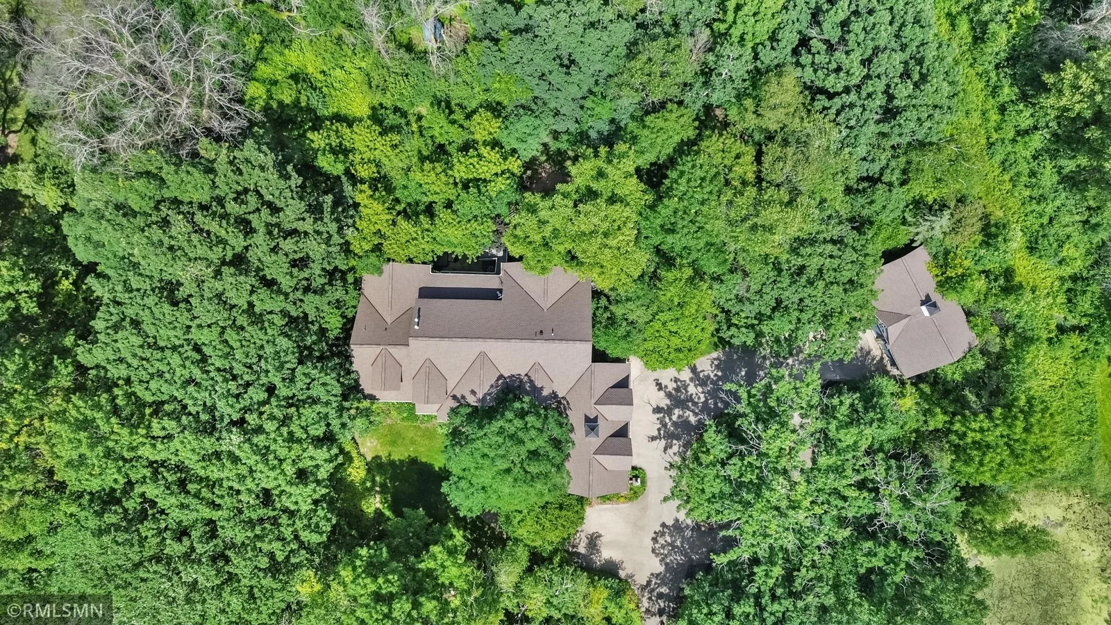 Ariel view shows newer architectural-shingled roofs on both buildings.