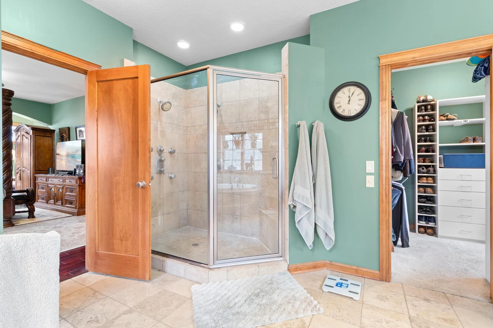 Primary bath. Custom tile shower with dual showers and controls. Tile sitting bench in shower.