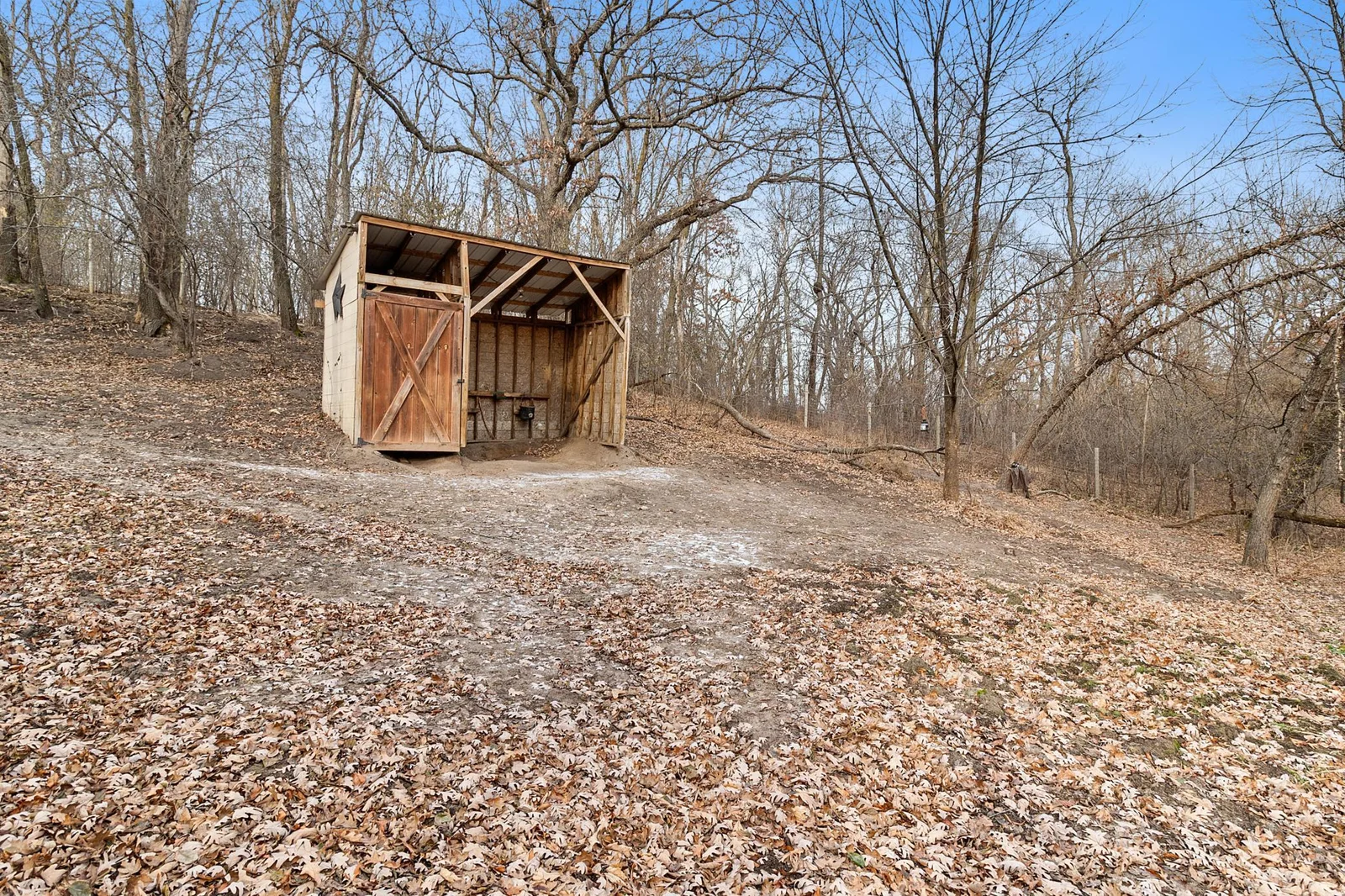 Fenced horse paddock of approximately one acre.  With run-in with tack closet and steel roof.