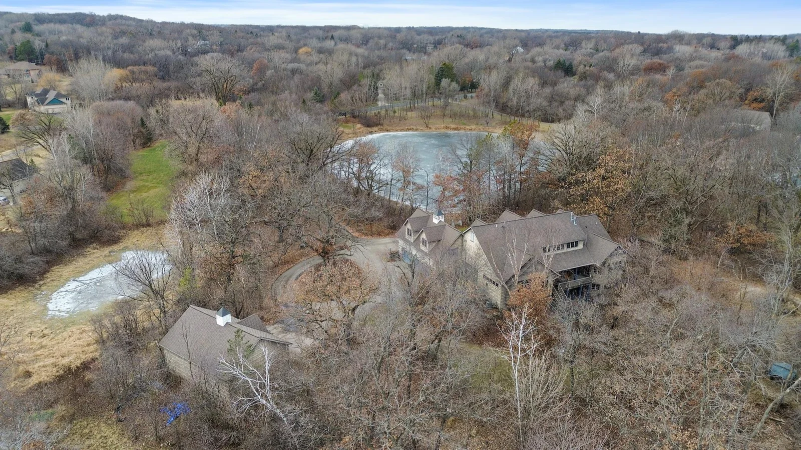View from back looking west. Detached garage showing the two ponds that are part of the property.