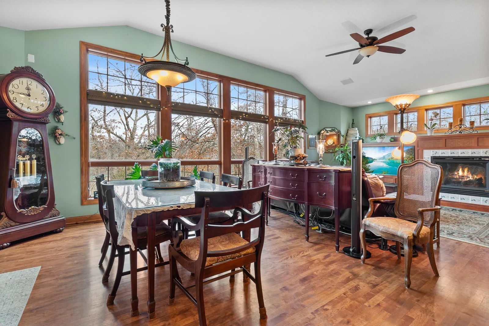 Breakfast area open to family room. Floor-to-ceiling windows overlooking back yard.