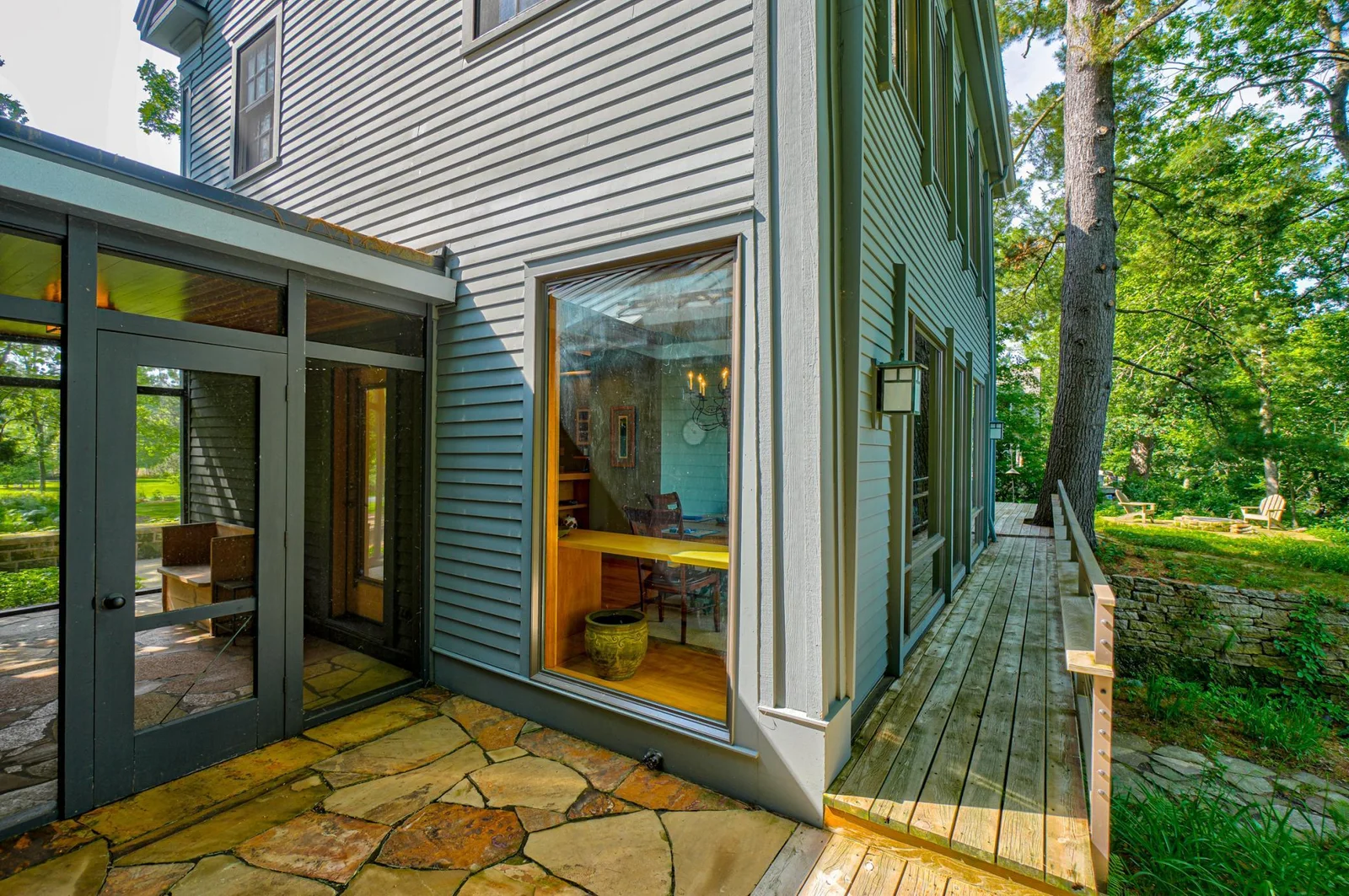 The stone patios represent another example of materials and design integration that so beautifully ties elements together. This patio is just outside the south screen porch.