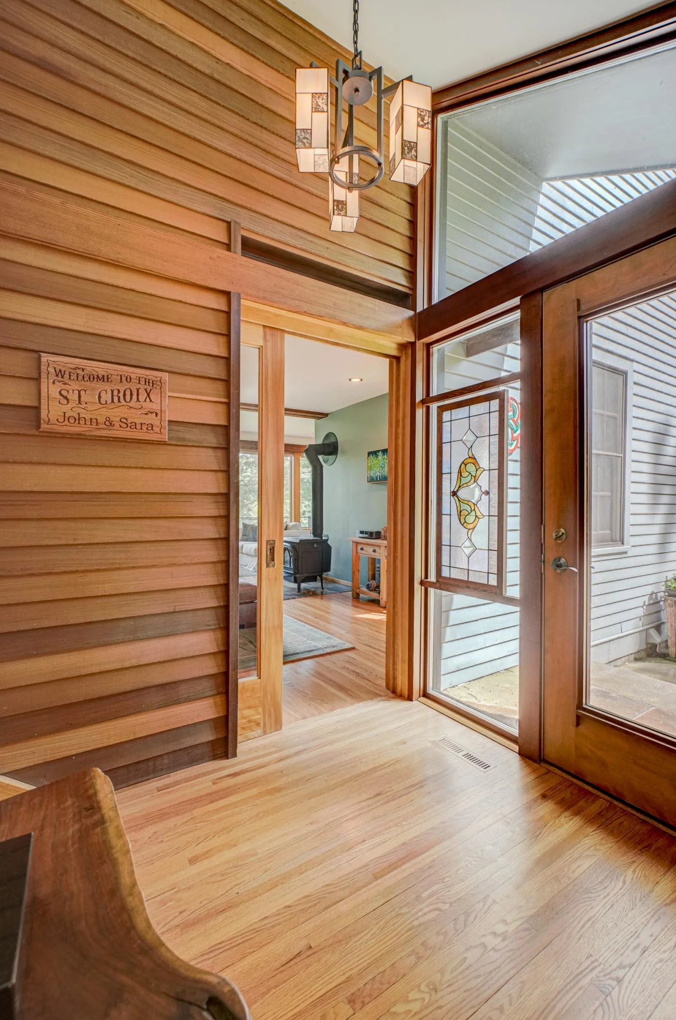 The generous and beautifully designed entrance to the home. The pocket door to the living room allows for the option to close off the entry.