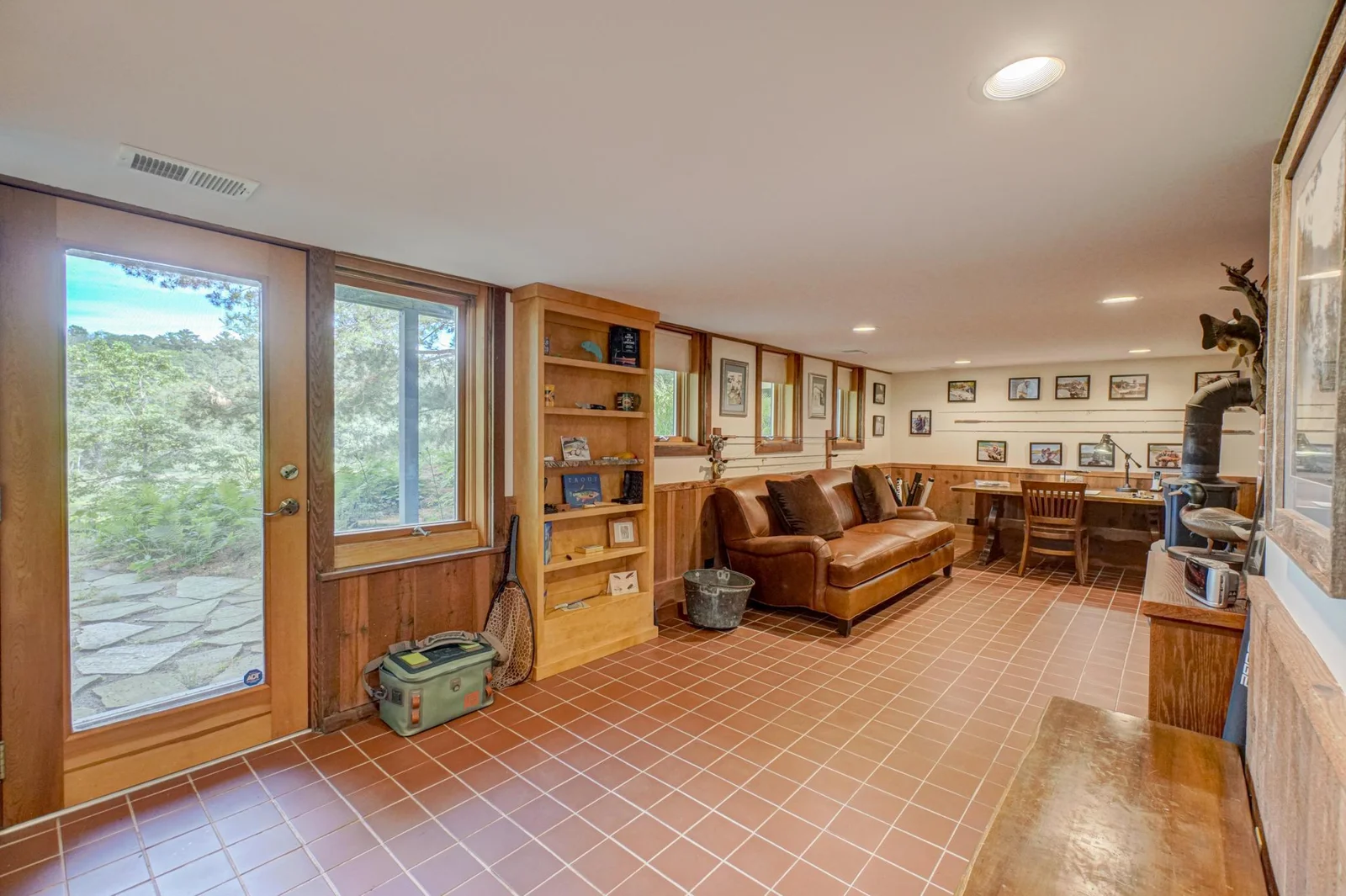 The lower level space gets lots of morning light and walks out to a stone patio. This large room could be used as an office, bedroom, family room, or art studio.