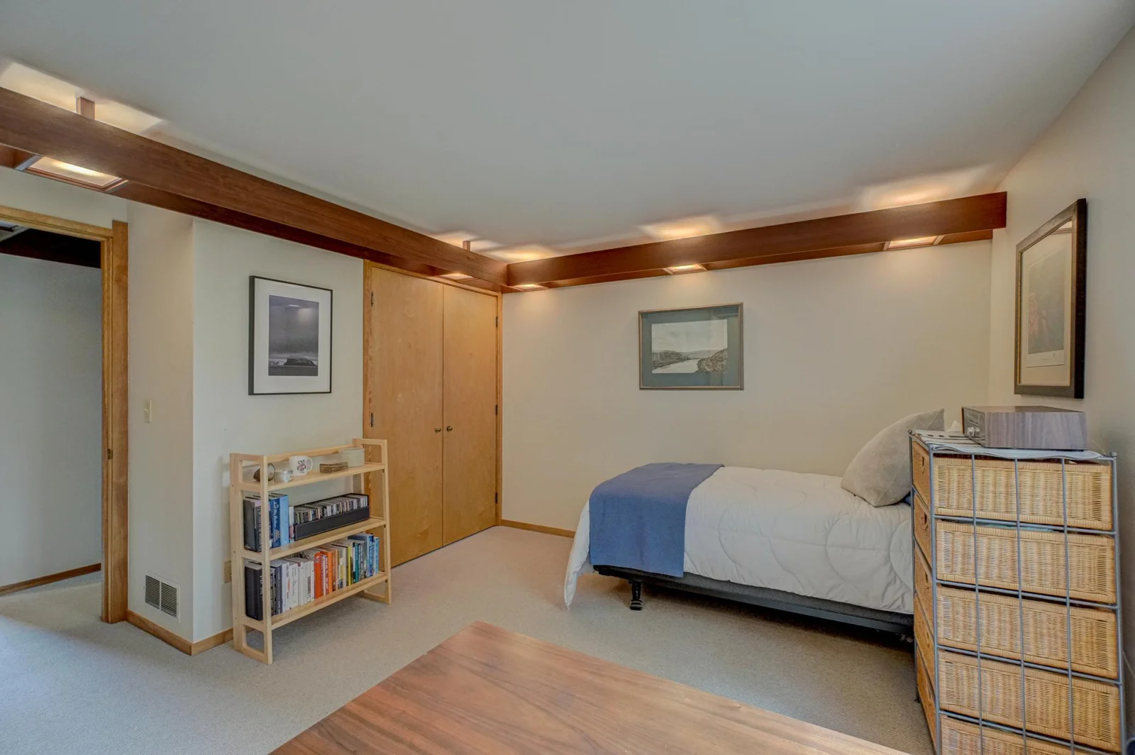 The guest bedroom on the second floor with its custom maple closet doors and soffit lighting.