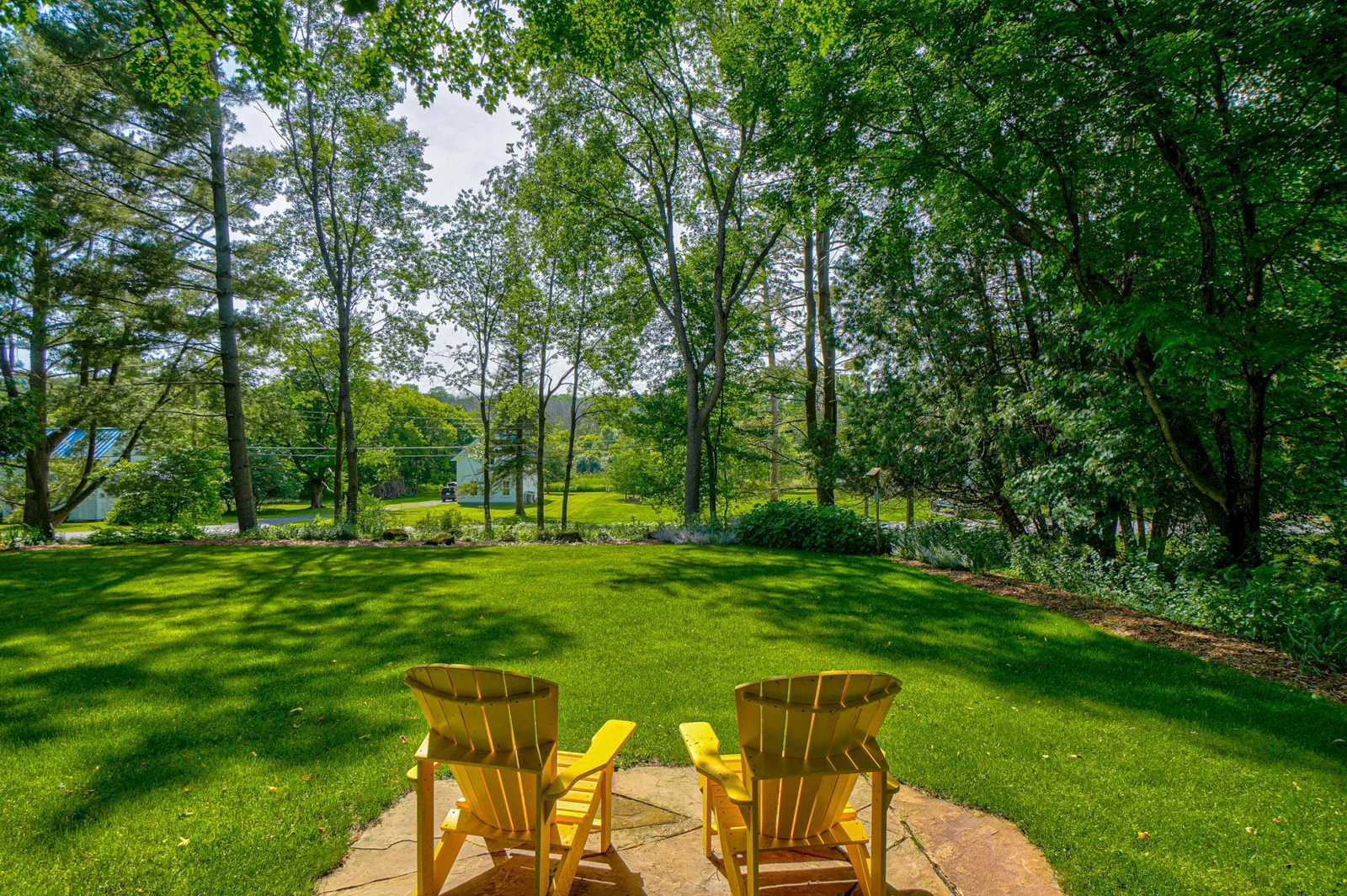 The front lawn is bordered by perennial gardens. There is lots of space for croquet, badminton, or soccer.