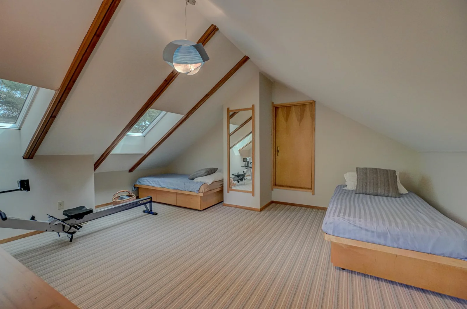 The third story attic space is a perfect sleepover room. Through the raised door is a spacious walk-in closet with additional knee-wall storage areas.