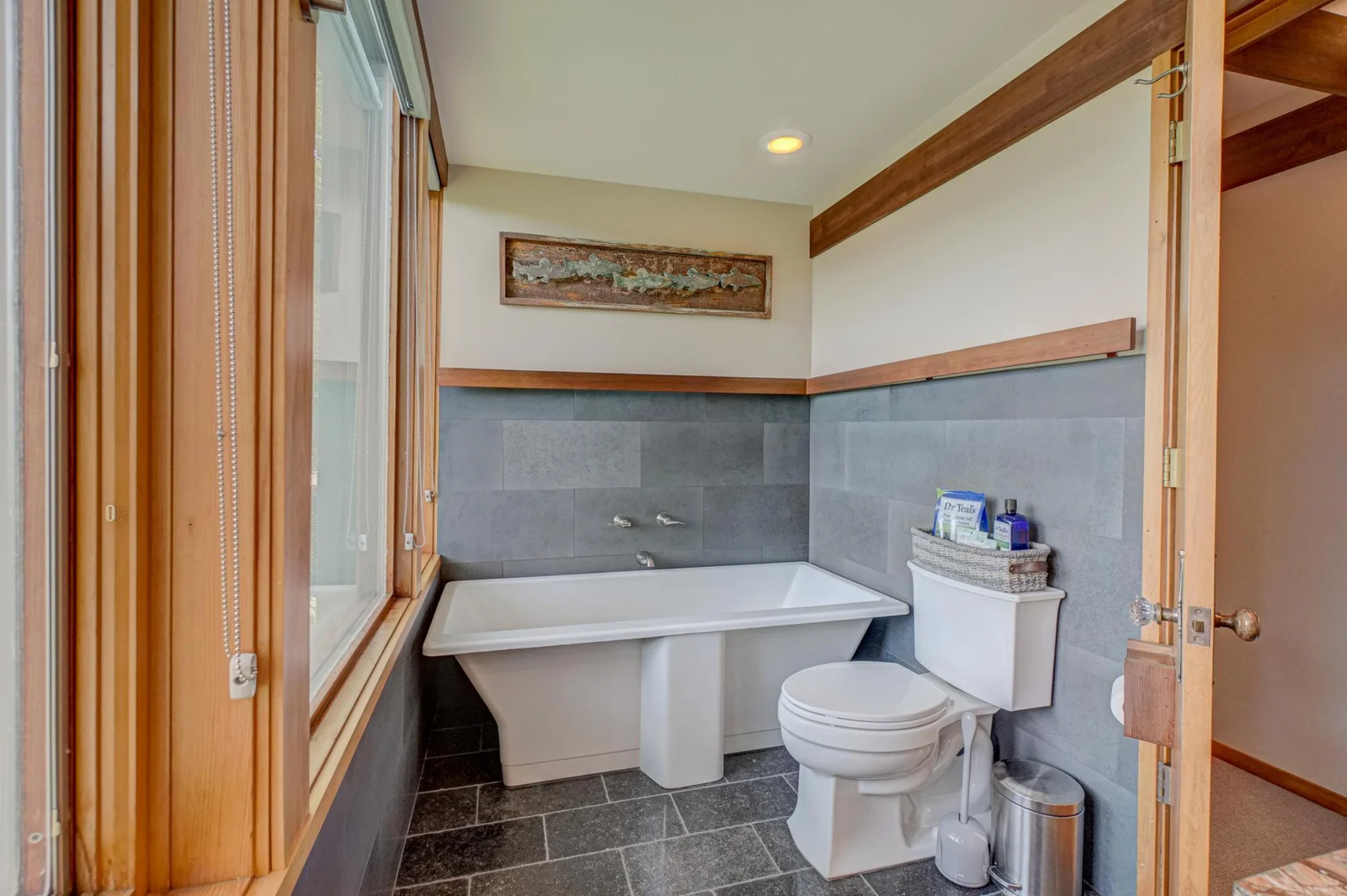 The luxurious Kohler soaking tub has faucets located on the slate-tiled wall so you can lie back and enjoy....