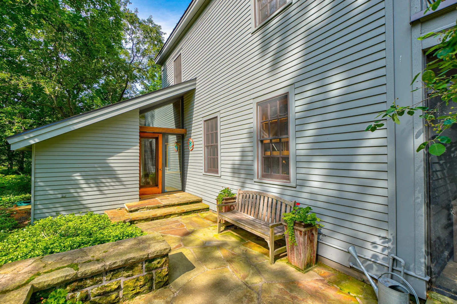 The front entrance to the home features a stone wall hewn by local stonemason Mike Tibbets.